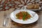 The vegetarian salad with vegetables, arugula and sprouted quinoa and unleavened bread.