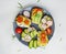 Vegetarian sandwiches with cream cheese and vegetables: cucumber, radish, tomato, avocado, rosemary on a white background.