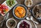 Vegetarian snack. Pumpkin, beets hummus, beans and mushroom pate, vegetables, nuts, bread on a wooden table, top view. Flat lay.