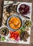 Vegetarian snack table. Pumpkin, beets hummus, beans and mushroom pate, vegetables, nuts, bread on a wooden table, top view.