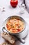 Vegetarian spicy tomato rice soup on grey concrete background