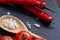 Vegetarian still life with fresh grape tomatoes, pepper and salt in wooden spoon on wooden background, selective focus