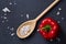 Vegetarian still life with fresh grape tomatoes, pepper and salt in wooden spoon on wooden background, selective focus