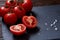 Vegetarian still life with fresh grape tomatoes, pepper and salt in wooden spoon on wooden background, selective focus