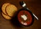 Vegetarian tomato soup with crackers on a country wooden table