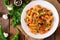 Vegetarian Vegetable pasta Fusilli with zucchini, mushrooms and capers in white bowl