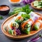 Vegetarian vietnamese spring rolls with spicy sauce, carrot, cucumber, red cabbage and rice noodl