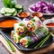 Vegetarian vietnamese spring rolls with spicy sauce, carrot, cucumber, red cabbage and rice noodl