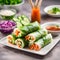 Vegetarian vietnamese spring rolls with spicy sauce, carrot, cucumber, red cabbage and rice noodl