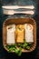 Vegetarian wraps on paper plate and wooden cutlery, top view, close up.