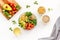 Veggie bowl. Vegetable salad with quinoa, avocado, tomato, spinach and chickpeas - on white table. Top view