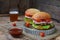 Veggie burgers with chop of eggplant, lettuce, pickled onions, tomato on a brown wooden background. Vegetarian lunch or dinner ide