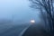 Vehicle coming out of a thick fog with switch on headlights