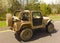 A vehicle covered with mud driving along the interstate