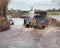 Vehicle Driving Through Flood Water On Road