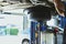 vehicle lift up by hydraulic for motor oil change & transmission inspection. changing engine oil in automobile repair service.