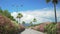 Vehicle moving on highway of resort city lined up with blossoming bushes, summer