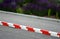 Vehicle protection entry barrier, lane-to-lane crossing road markings deceleration element in traffic red white plastic fastened