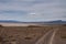 Vehicle trail and dry lake in High Desert, NV, USA