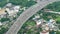 Vehicles drive along the expressway surrounded by the city\\\'s lush greenery