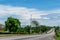 Vehicles driving along the Elegant Corridor highway in Montego Bay, Jamaica. Cars drive on the left hand side of the road.