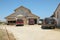 Vehicles parked outside a warehouse on a California ranch.