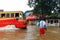 Vehicles pass through the flooded roads