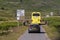 Vehicles touring the Isle of Mull, Scotland approach a T junction with signpost.