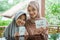veiled asian mother and daughter holding eid mubarak greeting cards