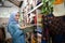 a veiled business woman piles up a pile of clothes on a clothes rack