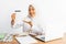 veiled student of vocational high school at desk showing card