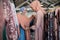 veiled waitresses while serving female shoppers choosing clothes on hangers