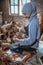 veiled water hyacinth craftswoman sitting on the floor weaving handicrafts