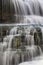 Veils of Water Falling on Steps of Rock with Moss