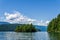 veiw from the shore to Harrison Lake british columbia Canada green land blue water and sky