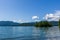 Veiw from the shore to Harrison Lake british columbia Canada green land blue water and sky