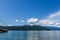 Veiw from the shore to Harrison Lake british columbia Canada green land blue water and sky