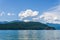 Veiw from the shore to Harrison Lake british columbia Canada green land blue water and sky