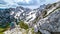 Velika Baba  - A hiking woman with helmet resting on a hiking trail in Kamnik Savinja Alps in Carinthia, Austria, Slovenia