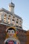 Veliky Novgorod, Russia, May 2018.Traditional Russian wooden nesting doll on the background of the fortress wall and the bell towe