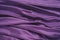 Velour fabric, similar to silk. Textiles in a folds and beautiful waves. Purple, pink, magenta shades on the drapery