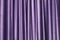 Velour purple background. Draped fabric in pleats