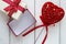 Velvet heart with a bow near the gift box