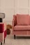 Velvet pastel pink couch in white living room interior with trendy design