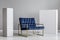 Velvet petrol blue armchair between two white blocks of wood