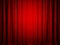 Velvet red stage curtain illuminated in the center