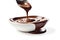 velvety chocolate sauce flows gracefully into a pristine white bowl, perfect for dessert or baking. culinary topics, or