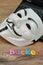 Vendetta mask displayed with hacker. This mask is a well-know symbol for the group Anonymo