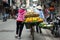 Vendor with bike of fruits on Hanoi street