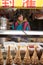 Vendor girl selling snacks at a street food stall in Luoyang Old City